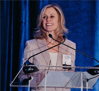 A woman standing at a speaking podium
